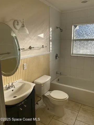 a bathroom with a tub and a large window