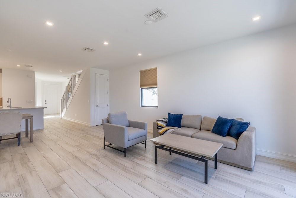 7565 Carnegie Way Naples, FL 34119 - Photo 15 of 50 Living area with recessed lighting and wood finish floors