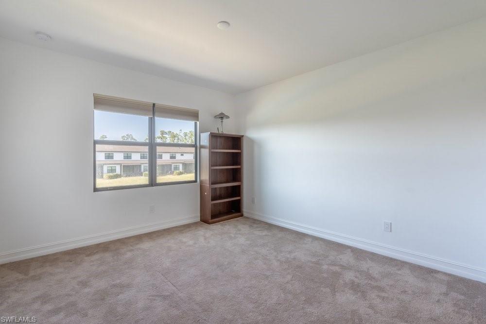 7565 Carnegie Way Naples, FL 34119 - Photo 36 of 50 Unfurnished room featuring carpet floors and baseboards