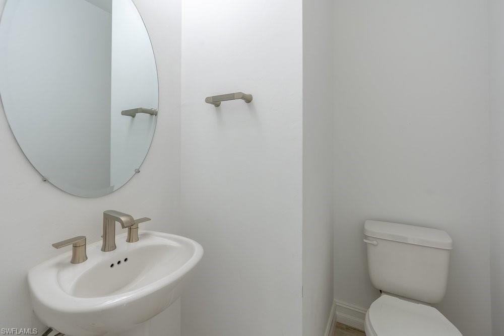 7565 Carnegie Way Naples, FL 34119 - Photo 5 of 50 Bathroom with a sink and toilet
