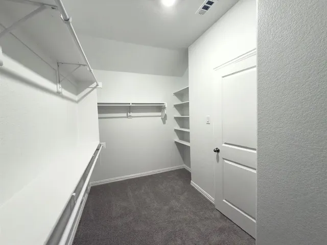 an empty room with a empty space and windows