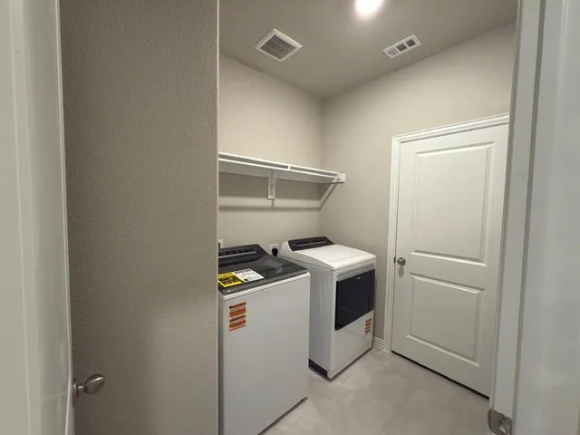 an empty room with windows and ceiling fan