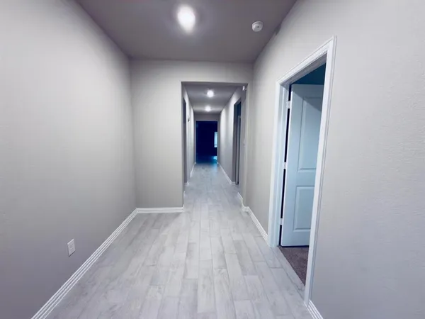 a view of hallway with wooden floor