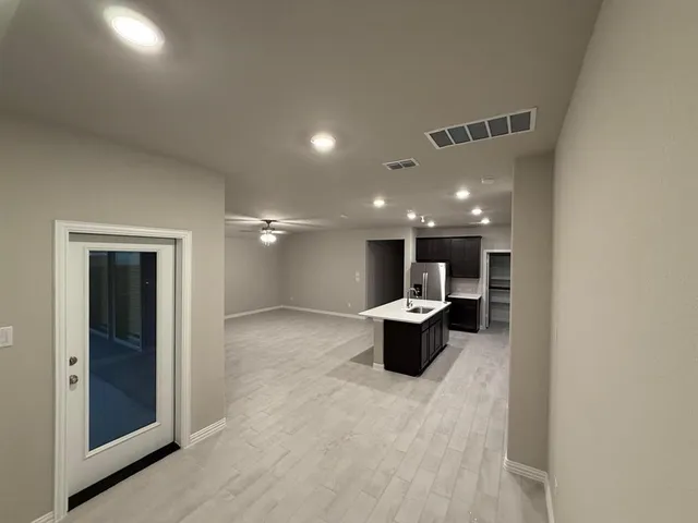 a view of an house with backyard and porch