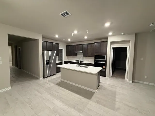a view of a big room with a table and a chair