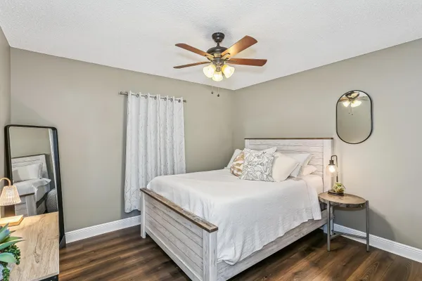 a bedroom with a bed and a chandelier