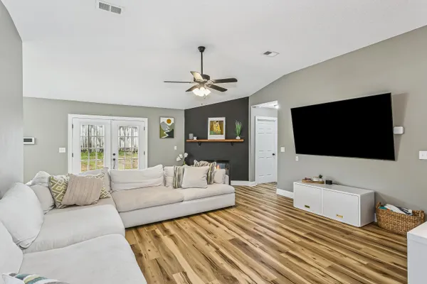 a living room with furniture and a flat screen tv