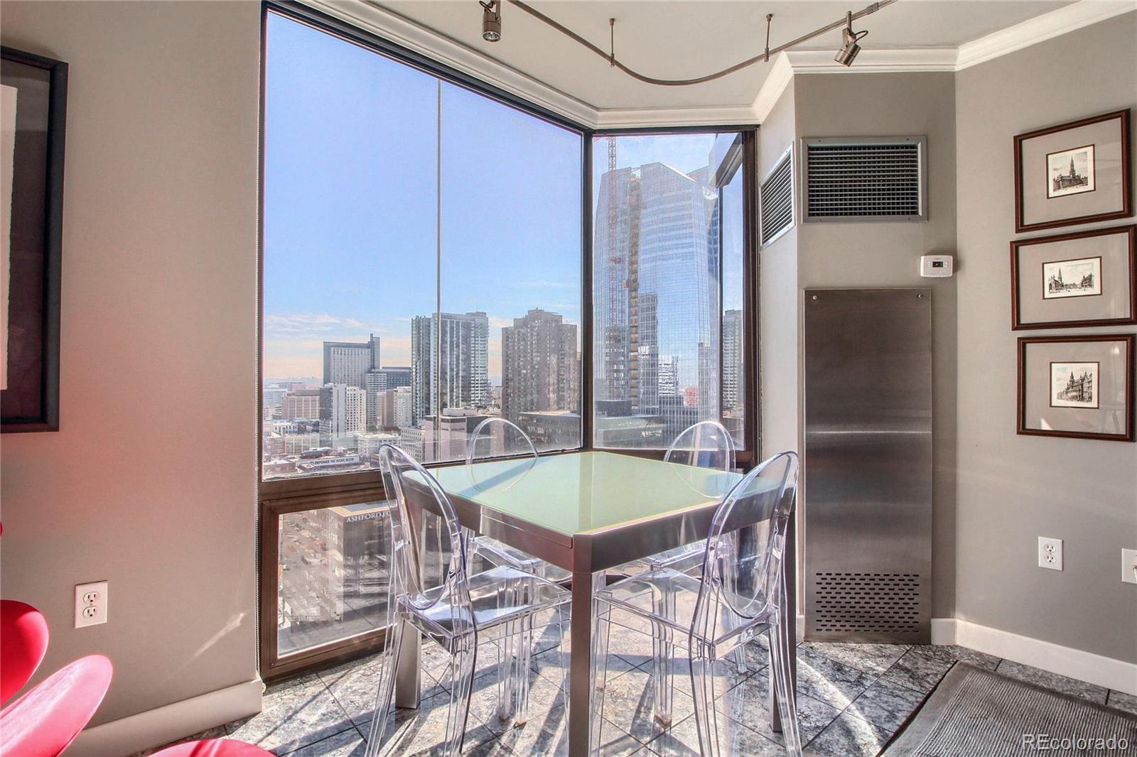 1625 Larimer Street, Unit 3104 Denver, CO 80202 - Photo 15 of 31 a dining room with a table and chairs