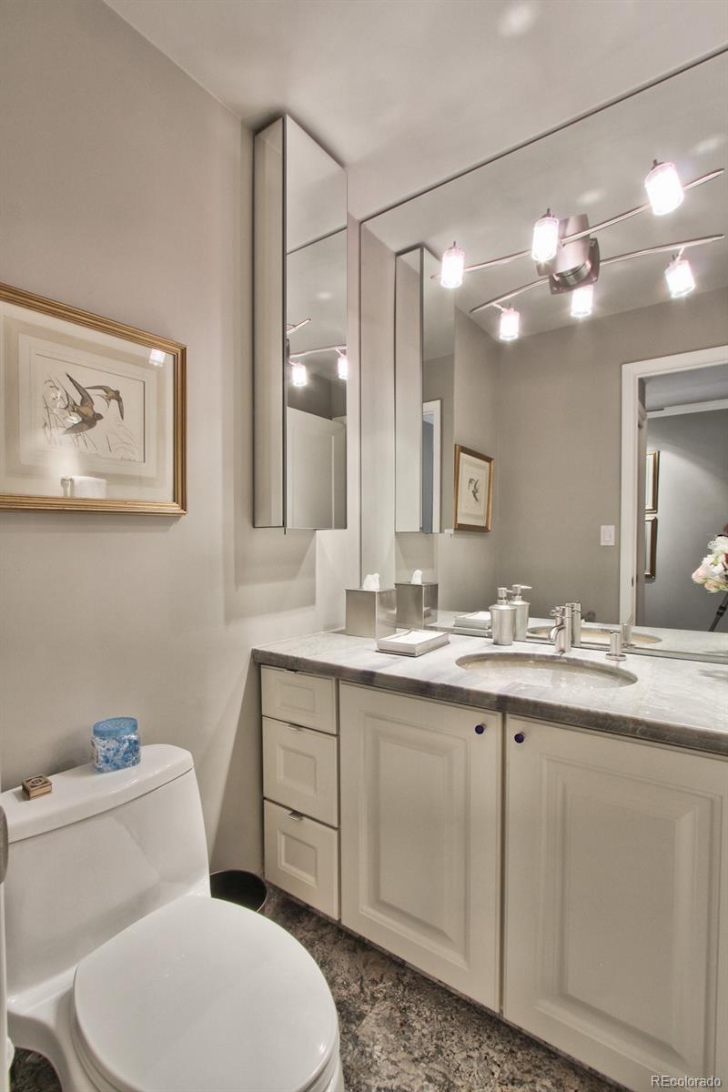 1625 Larimer Street, Unit 3104 Denver, CO 80202 - Photo 18 of 31 a bathroom with a toilet a sink and mirror