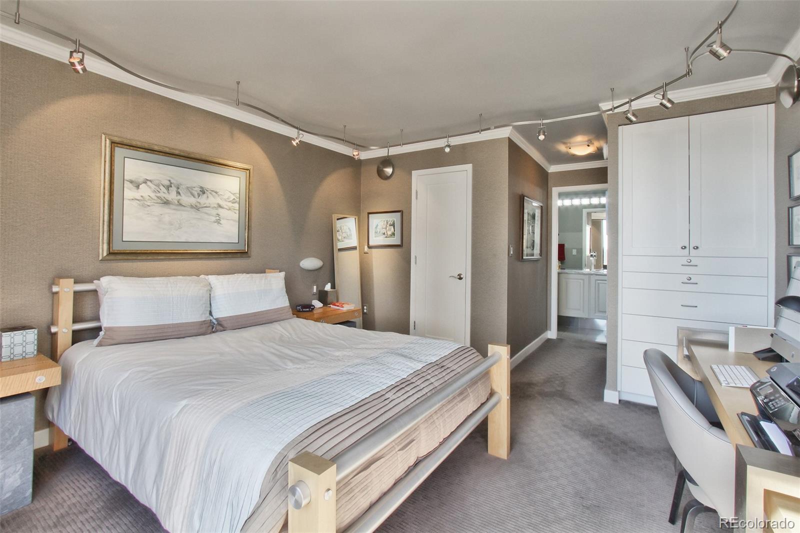 1625 Larimer Street, Unit 3104 Denver, CO 80202 - Photo 20 of 31 a spacious bedroom with a bed and furniture