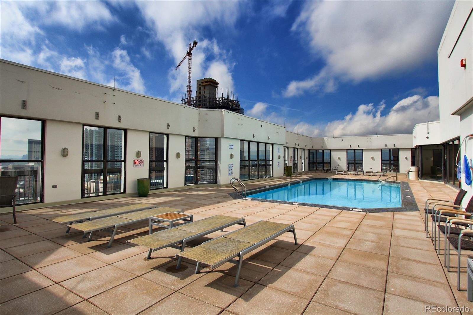 1625 Larimer Street, Unit 3104 Denver, CO 80202 - Photo 22 of 31 a view of a patio with swimming pool table and chairs