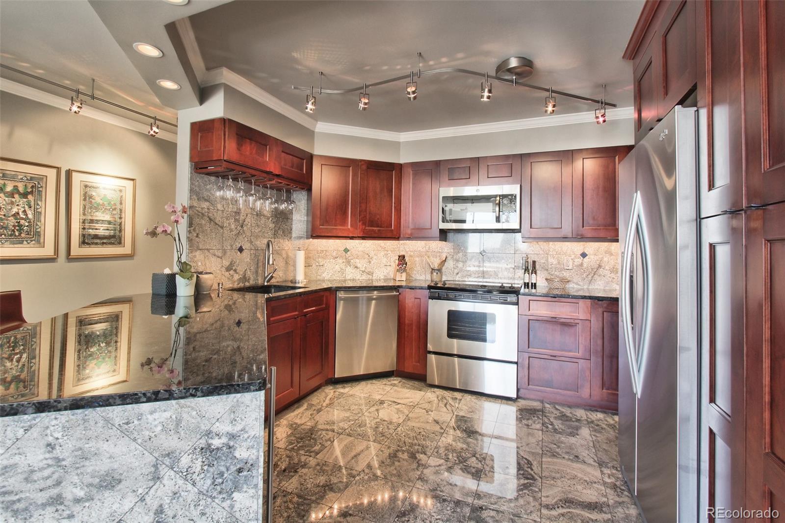 1625 Larimer Street, Unit 3104 Denver, CO 80202 - Photo 8 of 31 a kitchen with granite countertop a stove cabinets and refrigerator