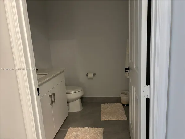 a bathroom with a granite countertop toilet and a shower
