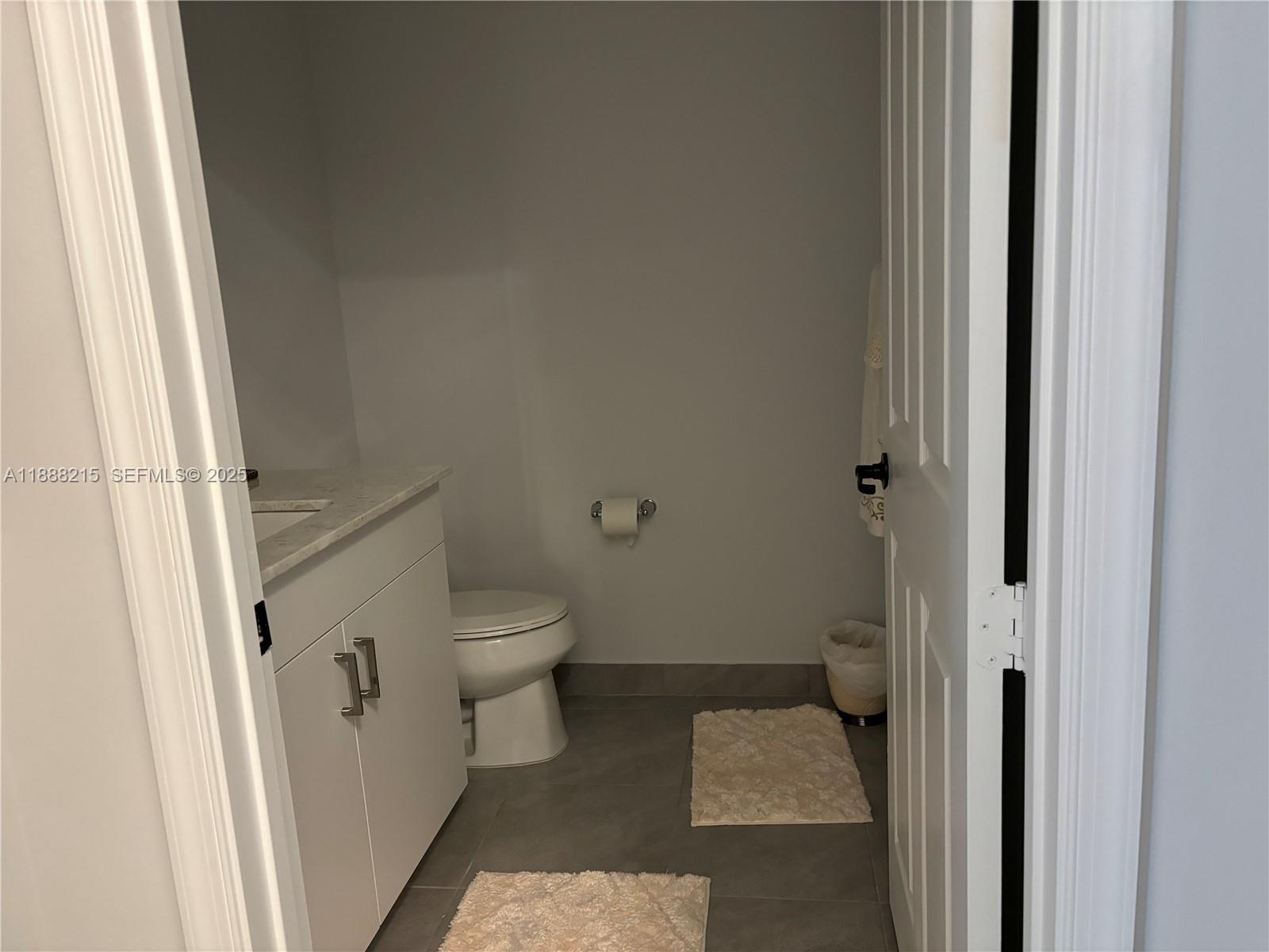 5107 Genoa Street, Unit 5107 Ave Maria, FL 34142 - Photo 12 of 16 a bathroom with a granite countertop toilet and a shower