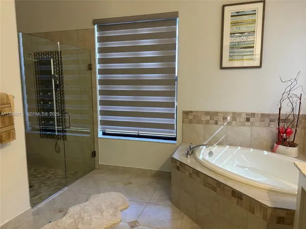 a bathroom with a bathtub and a shower