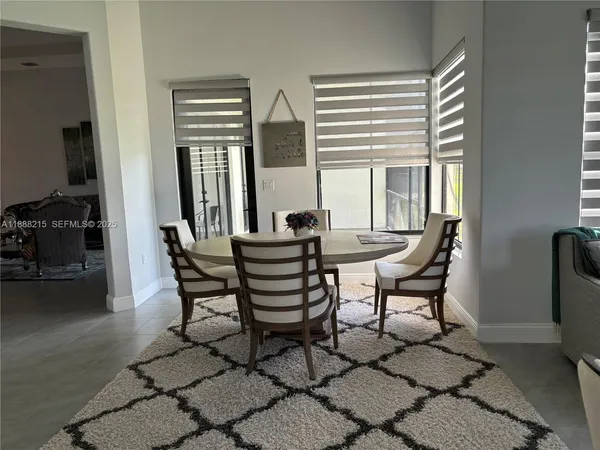 a view of a dining room with furniture and a window