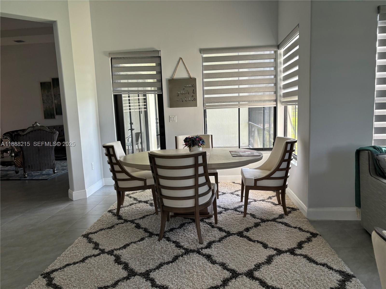 5107 Genoa Street, Unit 5107 Ave Maria, FL 34142 - Photo 7 of 16 a view of a dining room with furniture and a window