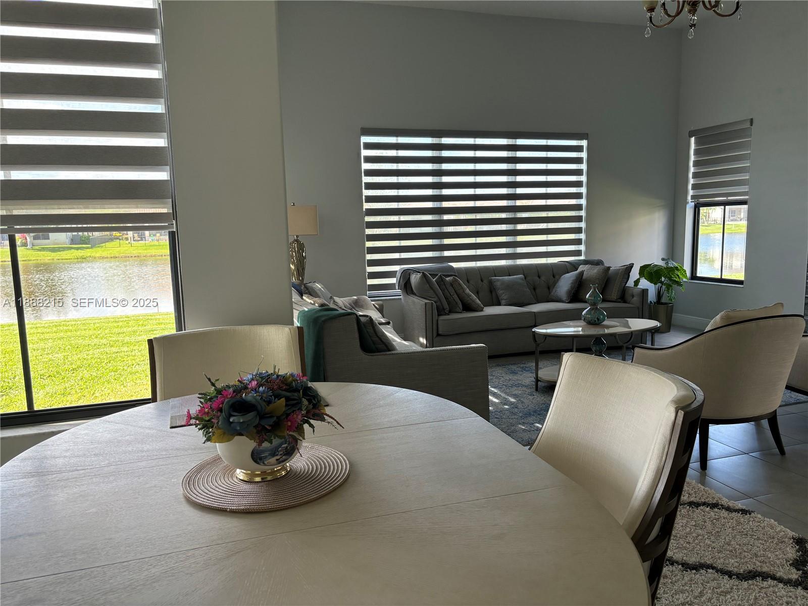 5107 Genoa Street, Unit 5107 Ave Maria, FL 34142 - Photo 8 of 16 a dining room with furniture and a window