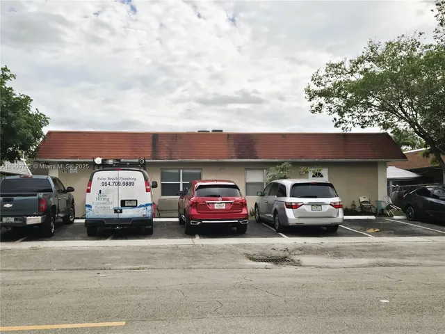 a view of a cars parked in front of a house