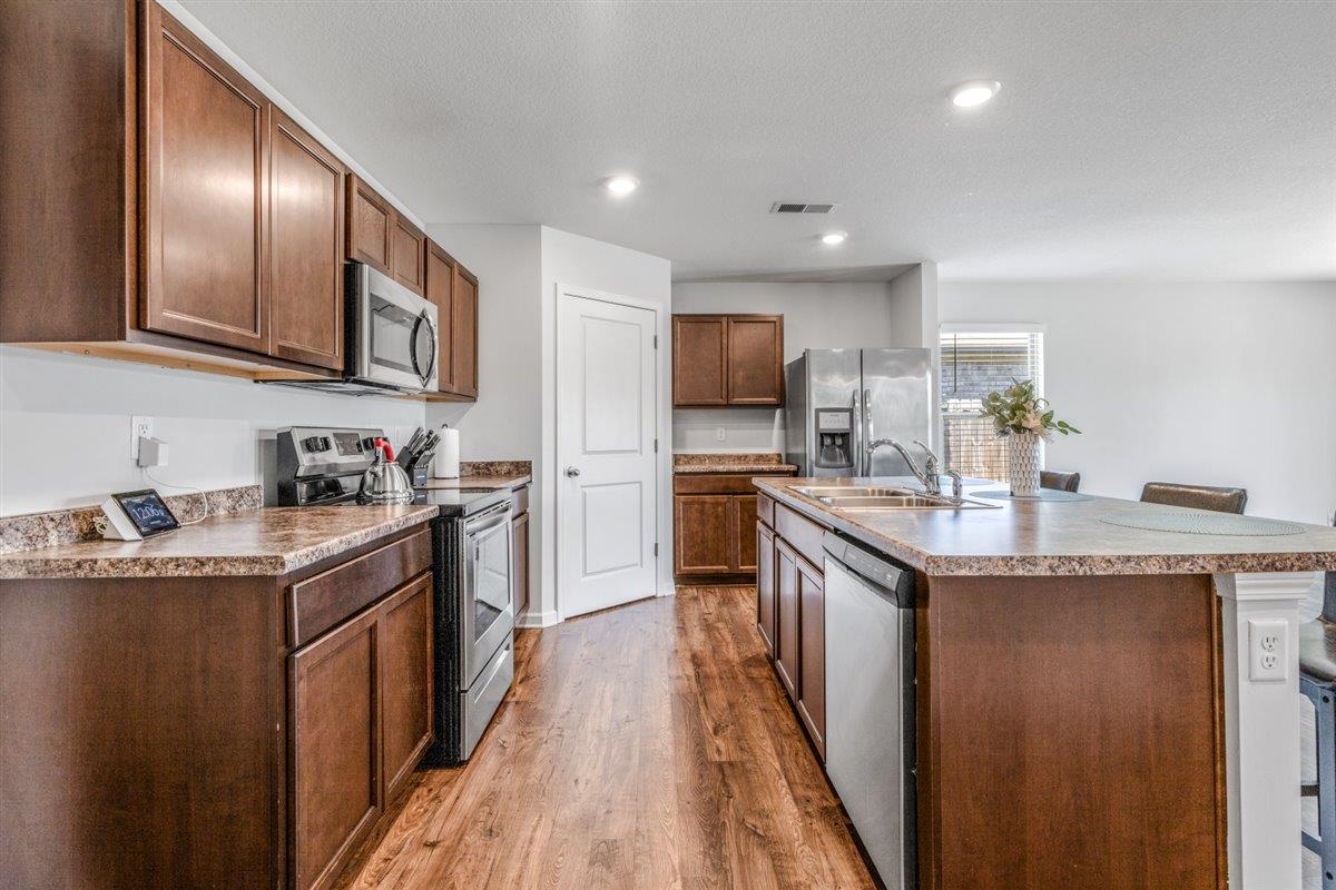 5320 Crossfield Road Memphis, TN 38109 - Photo 14 of 40 a kitchen with granite countertop stainless steel appliances and wooden cabinets