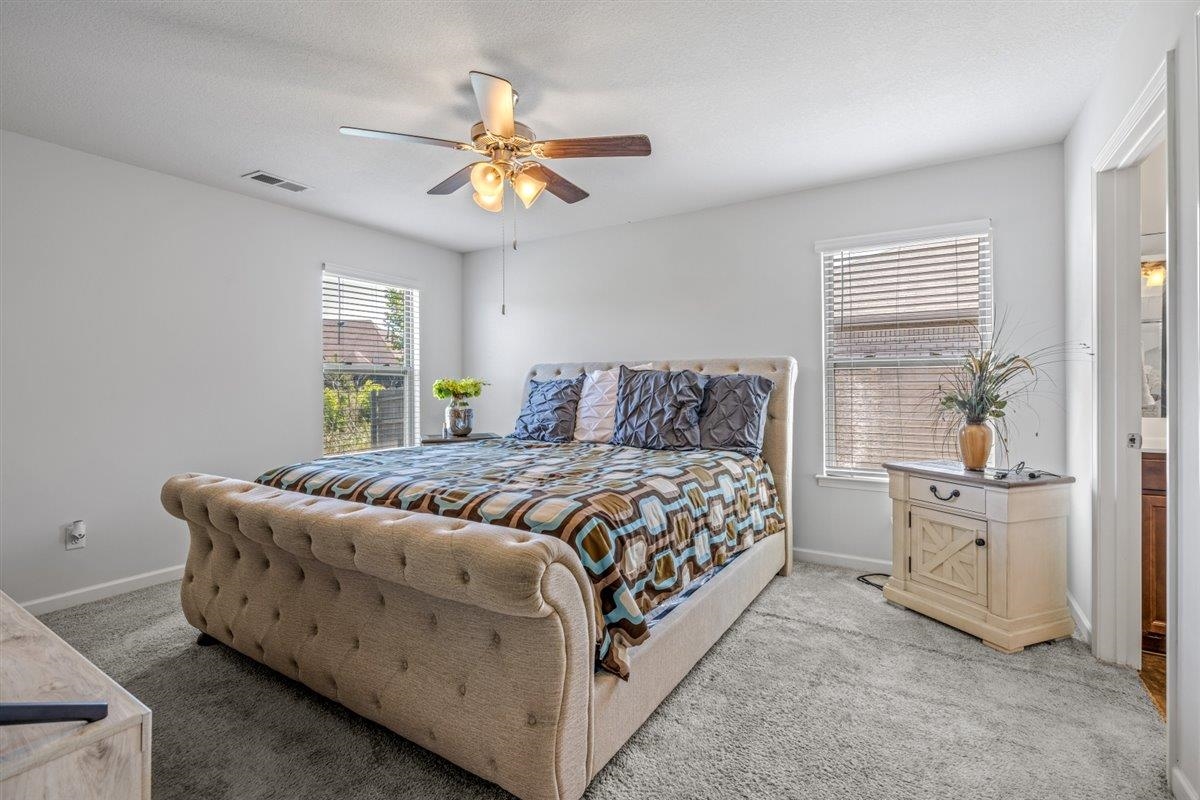 5320 Crossfield Road Memphis, TN 38109 - Photo 23 of 40 a bedroom with a bed and a chandelier