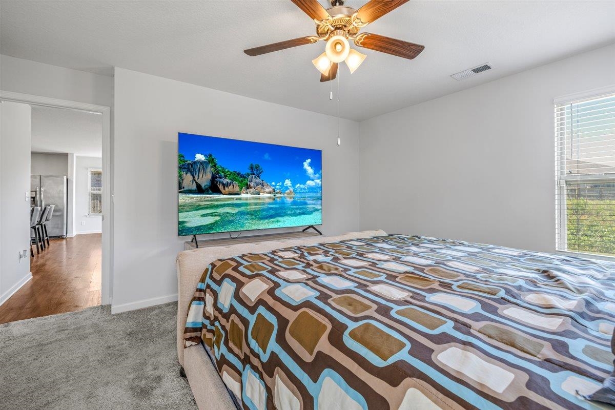 5320 Crossfield Road Memphis, TN 38109 - Photo 25 of 40 a bedroom with a bed and a chandelier