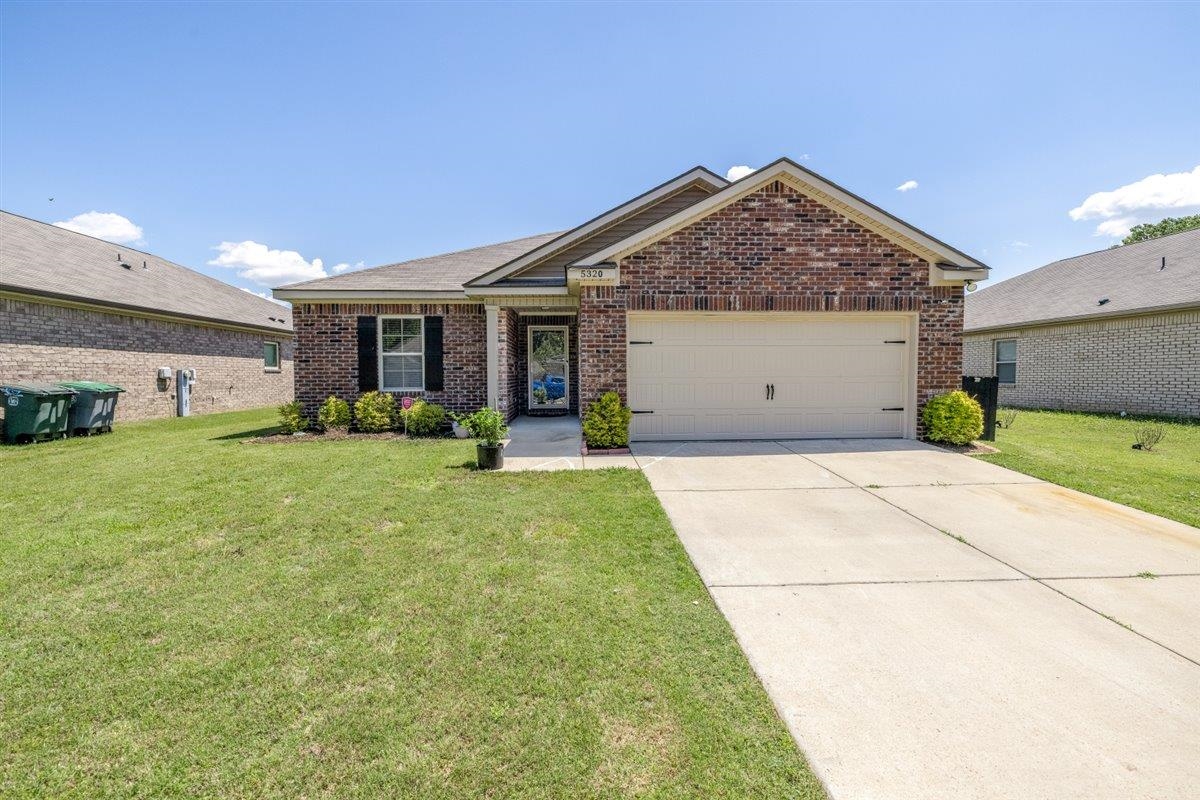 5320 Crossfield Road Memphis, TN 38109 - Photo 30 of 40 a view of a house with garage and garden