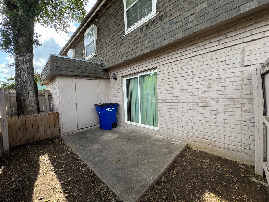 4902 West Wind Trail, Unit 101 Austin, TX 78745 - Photo 15 of 18 a view of a house with a large tree and wooden fence