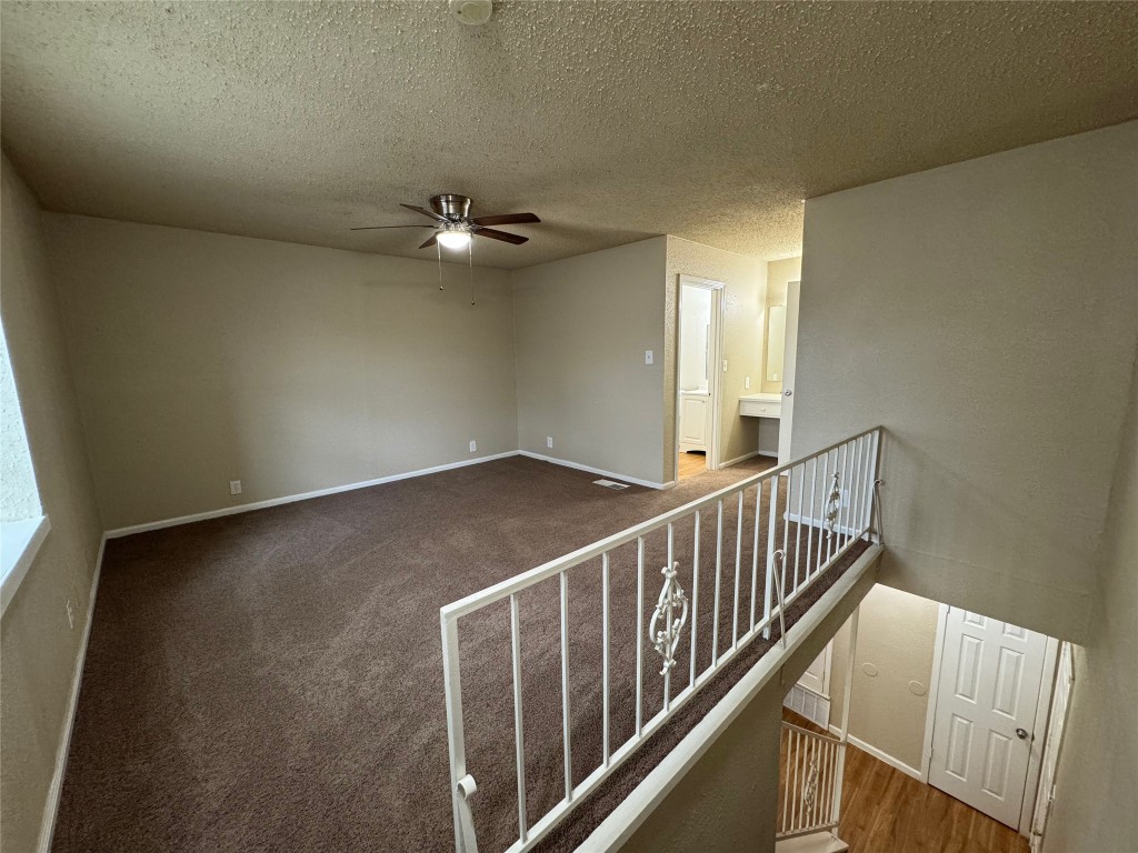 4902 West Wind Trail, Unit 101 Austin, TX 78745 - Photo 10 of 18 a view of a hallway with stairs