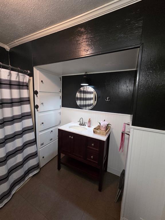 301 Old Plain Dealing Road Benton, LA 71006 - Photo 15 of 19 Compact bathroom featuring a dark wood-finish vanity with a white countertop and integrated sink