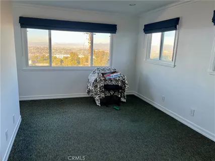 a bed sitting in a room next to a window