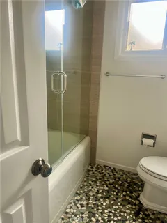 a bathroom with a bathtub and shower
