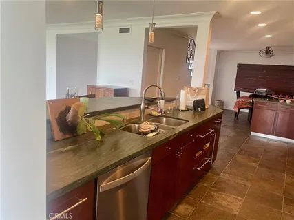a spacious bathroom with a granite countertop sink a mirror and shower