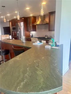 a large kitchen with stainless steel appliances a large counter top