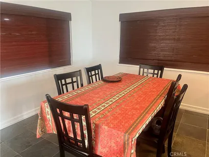 a dining room with furniture and wooden floor