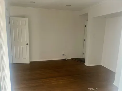 a view of wooden floor and brick walls