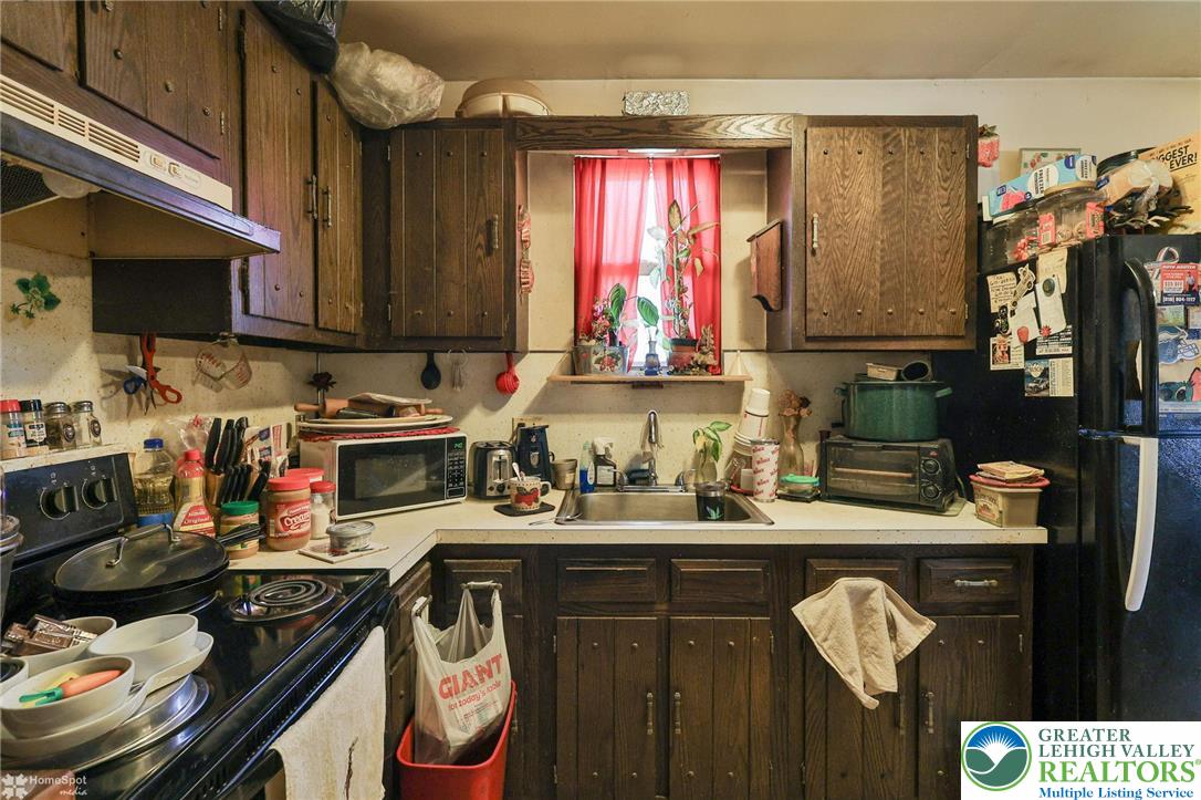 802 West Berwick Street Easton, PA 18042 - Photo 31 of 54 a kitchen with stainless steel appliances granite countertop a sink stove and cabinets