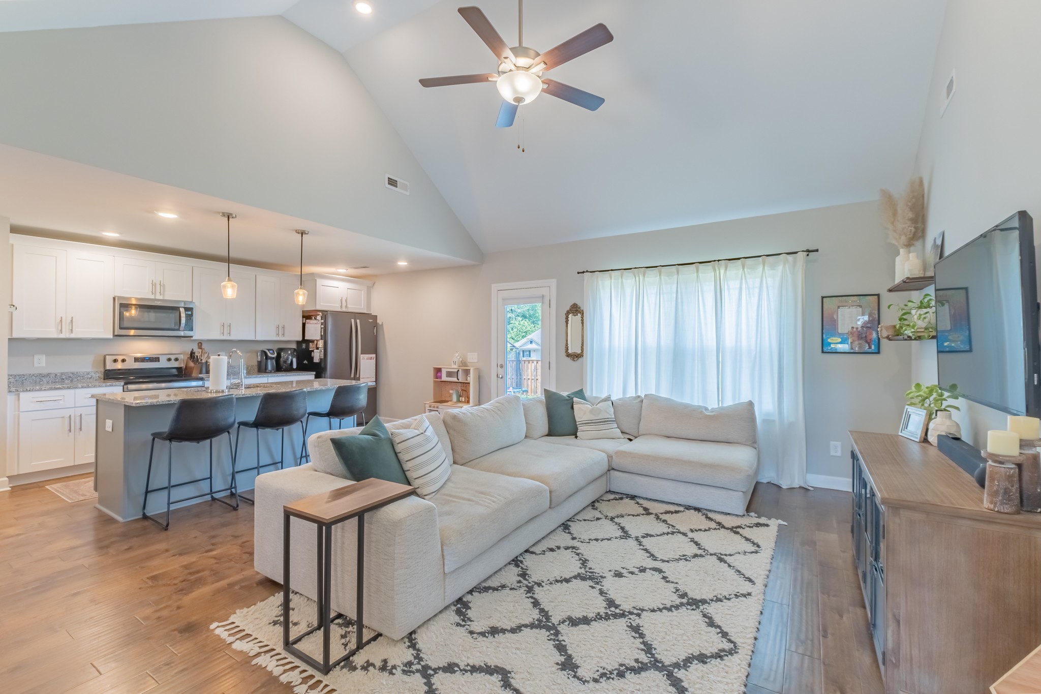 296 Spring Breeze Drive Tullahoma, TN 37388 - Photo 7 of 31 a living room with furniture kitchen view and a chandelier