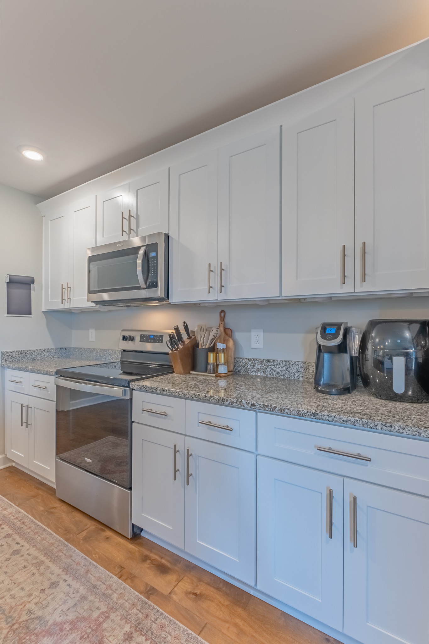 296 Spring Breeze Drive Tullahoma, TN 37388 - Photo 10 of 31 a kitchen with granite countertop white cabinets and stainless steel appliances