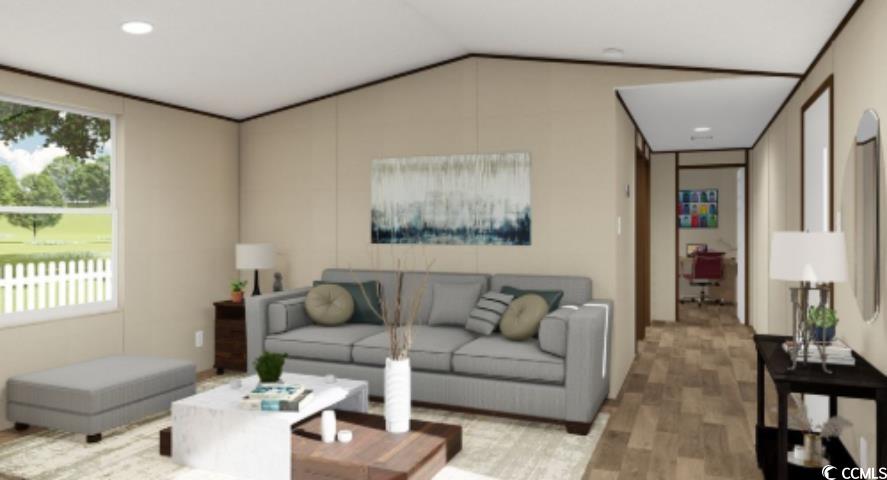 Living area featuring vaulted ceiling, wood finished floors, and recessed lighting