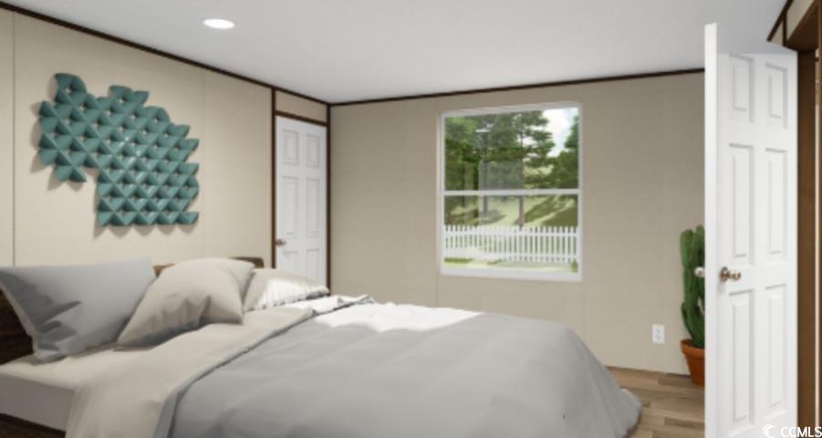 Bedroom with wood finished floors and recessed lighting