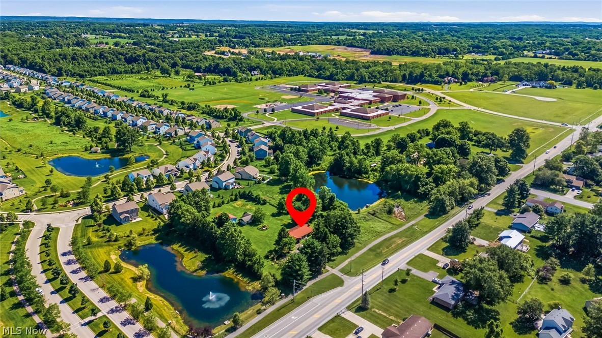6890 Refugee Road Pickerington, OH 43147 - Photo 46 of 49 Aerial perspective showcasing a residential area with green spaces, multiple ponds, and a large educational facility