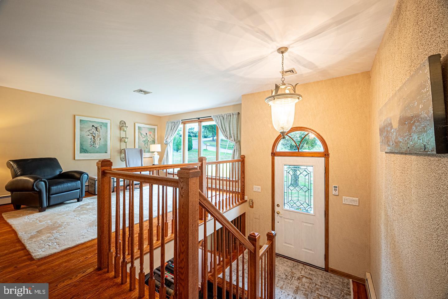 8 Devon Lane Media, PA 19063 - Photo 12 of 75 a view of a livingroom with furniture wooden floor windows and a chandelier