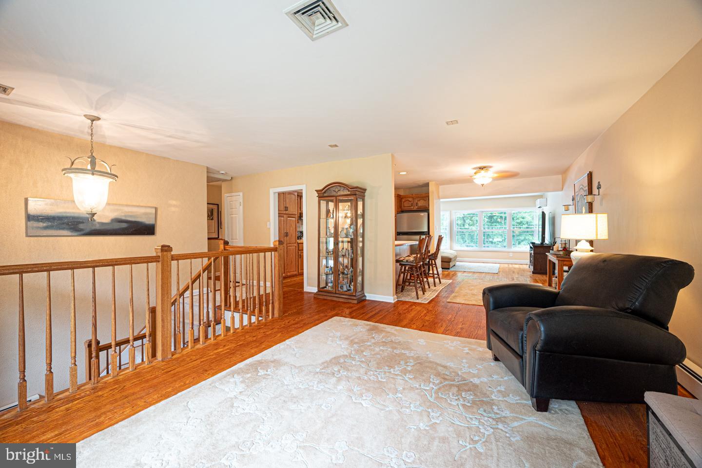 8 Devon Lane Media, PA 19063 - Photo 15 of 75 a living room with furniture a floor to ceiling window and a projector screen