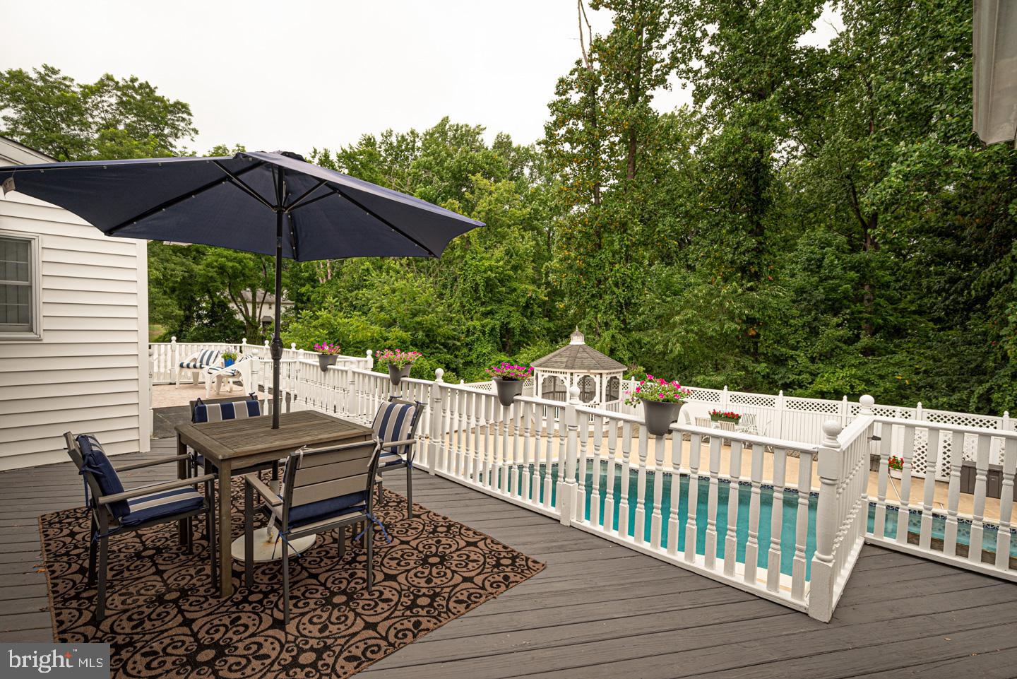 8 Devon Lane Media, PA 19063 - Photo 27 of 75 a view of a patio with a table and chairs under an umbrella