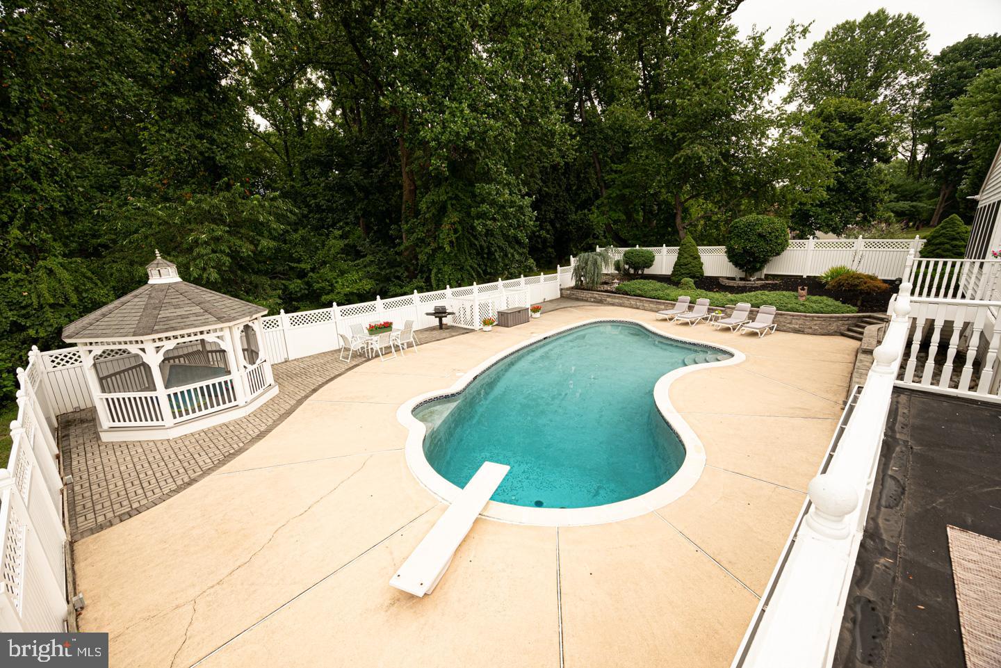 8 Devon Lane Media, PA 19063 - Photo 30 of 75 a view of a swimming pool with a patio