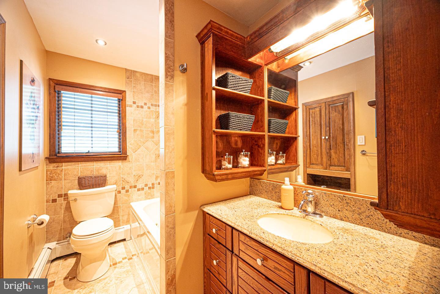 8 Devon Lane Media, PA 19063 - Photo 32 of 75 a bathroom with a granite countertop sink and a mirror