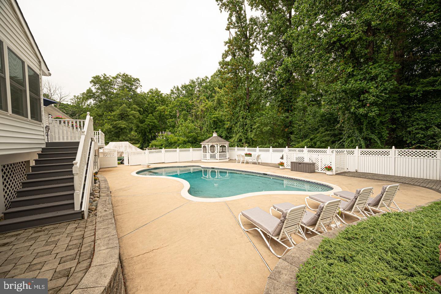 8 Devon Lane Media, PA 19063 - Photo 57 of 75 a view of a swimming pool with a patio