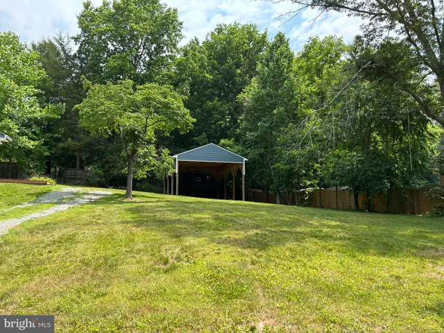 a view of a house with backyard porch and furniture