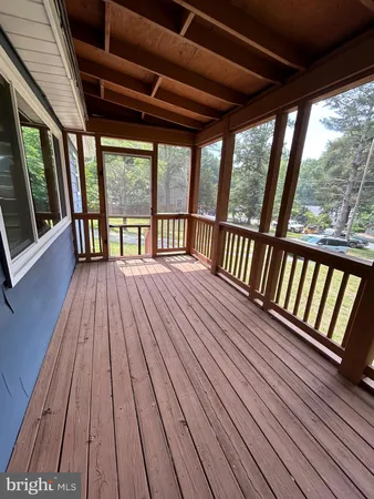 a view of outdoor space with deck and wooden floor